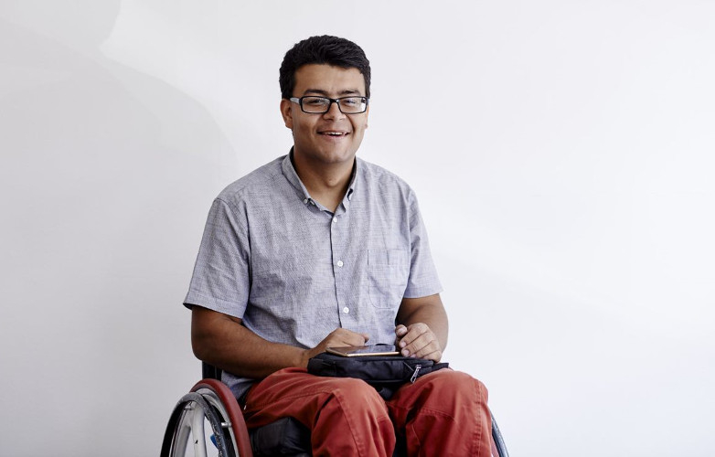 A picture of a smiling man in a wheelchair