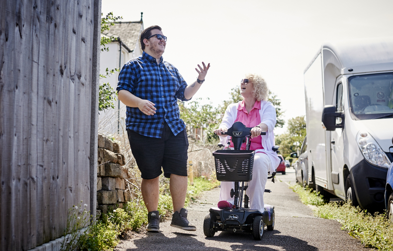 Bev on Class 2 mobility scooter talking to friend