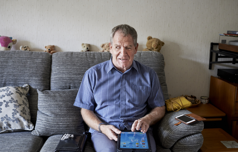 A blind man using a tablet