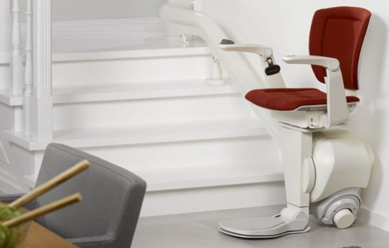 Image of an empty stairlift with a red seat cover
