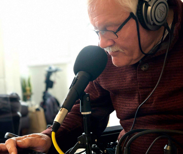Phil Friend recording another Gears, Gadgets and Gizmos Picutre of Dr Phil Friend with headphones on talking into a microphone