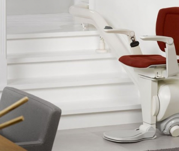 Image of an empty stairlift with a red seat cover