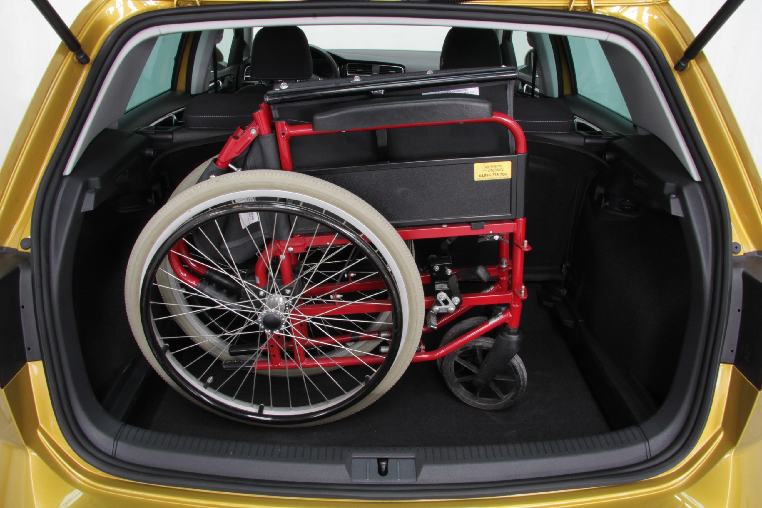 Picture of a folded wheelchair in a car boot